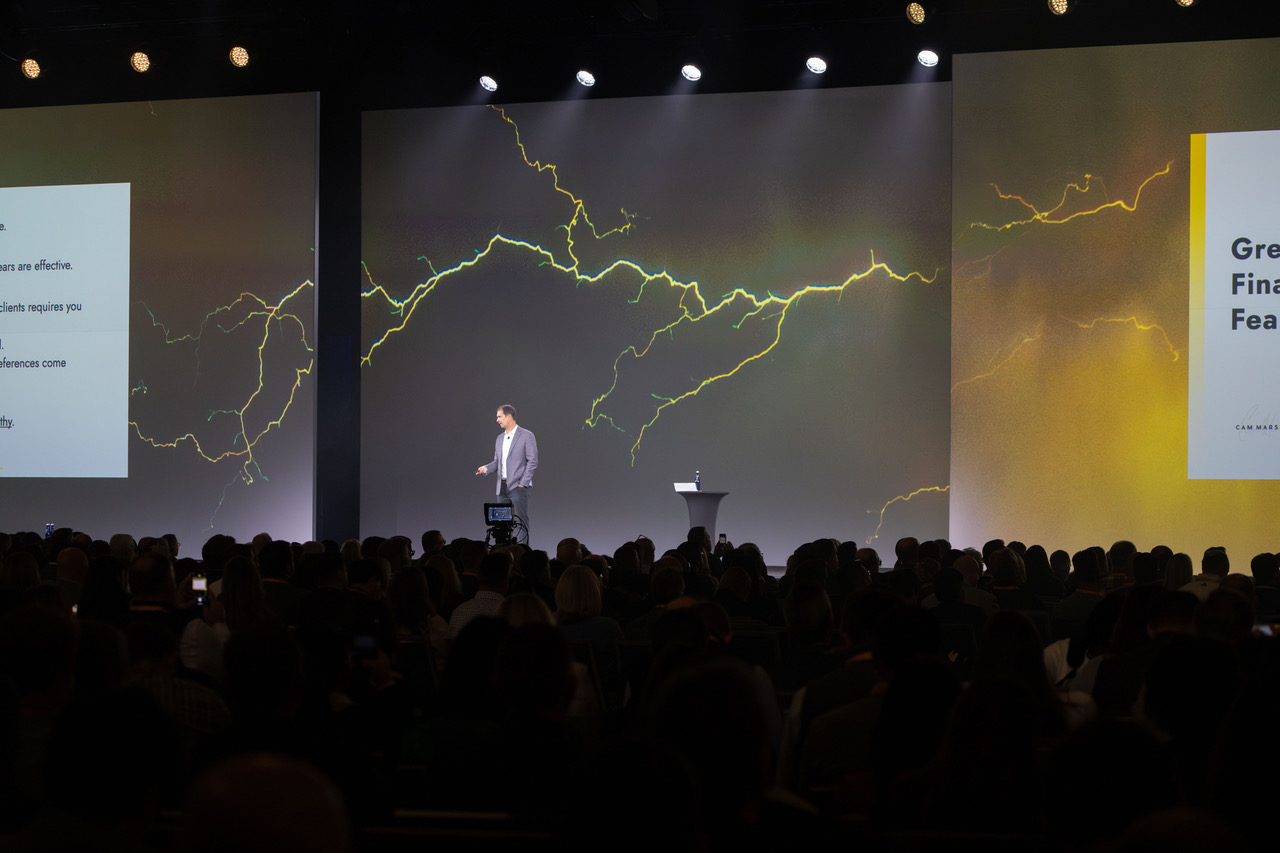 Cam Marston presenting to a conference audience